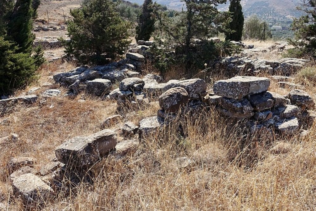 Kephala excavation site near Chondros in Viannos, Crete, with ancient stone remains and dry grass
